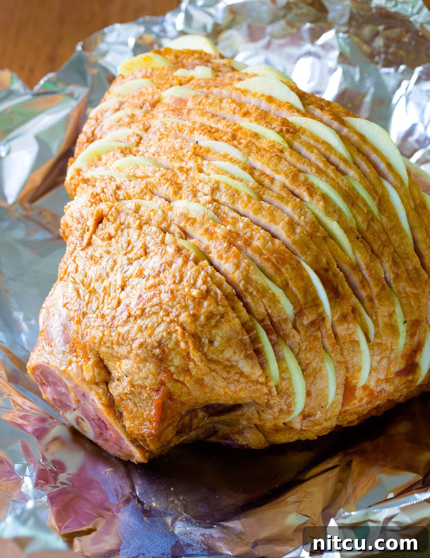 Honey-Glazed Ham with Roasted Apples 6 A spiral ham beautifully stuffed with thin slices of Granny Smith apples between each cut, ready for glazing and baking.