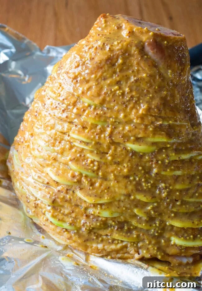 Honey-Glazed Ham with Roasted Apples 8 The spiral ham, already partially glazed, resting on a baking sheet, ready to go into the oven.