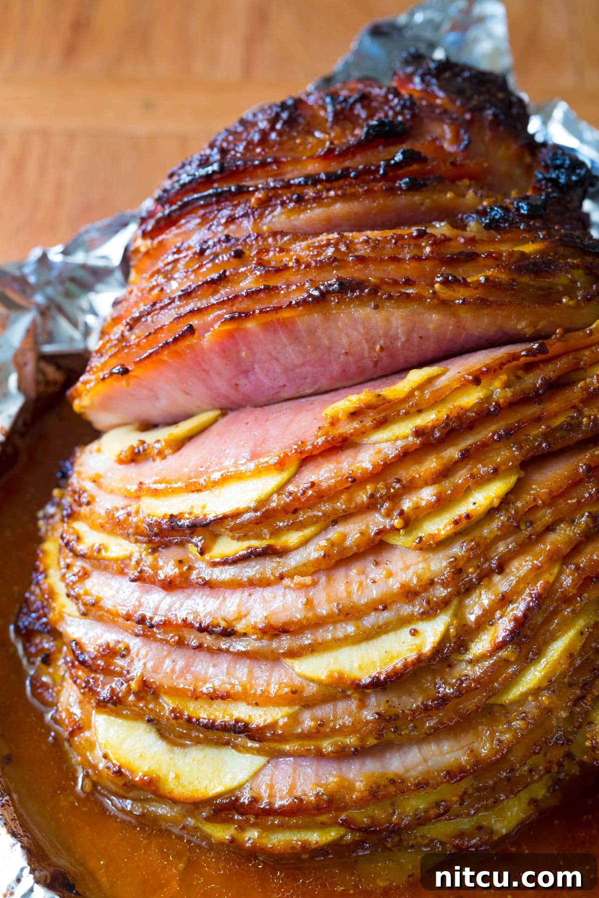 Honey-Glazed Ham with Roasted Apples 10 A close-up view of the perfectly cooked, juicy ham stuffed with apples, showcasing its tender texture and golden glaze.