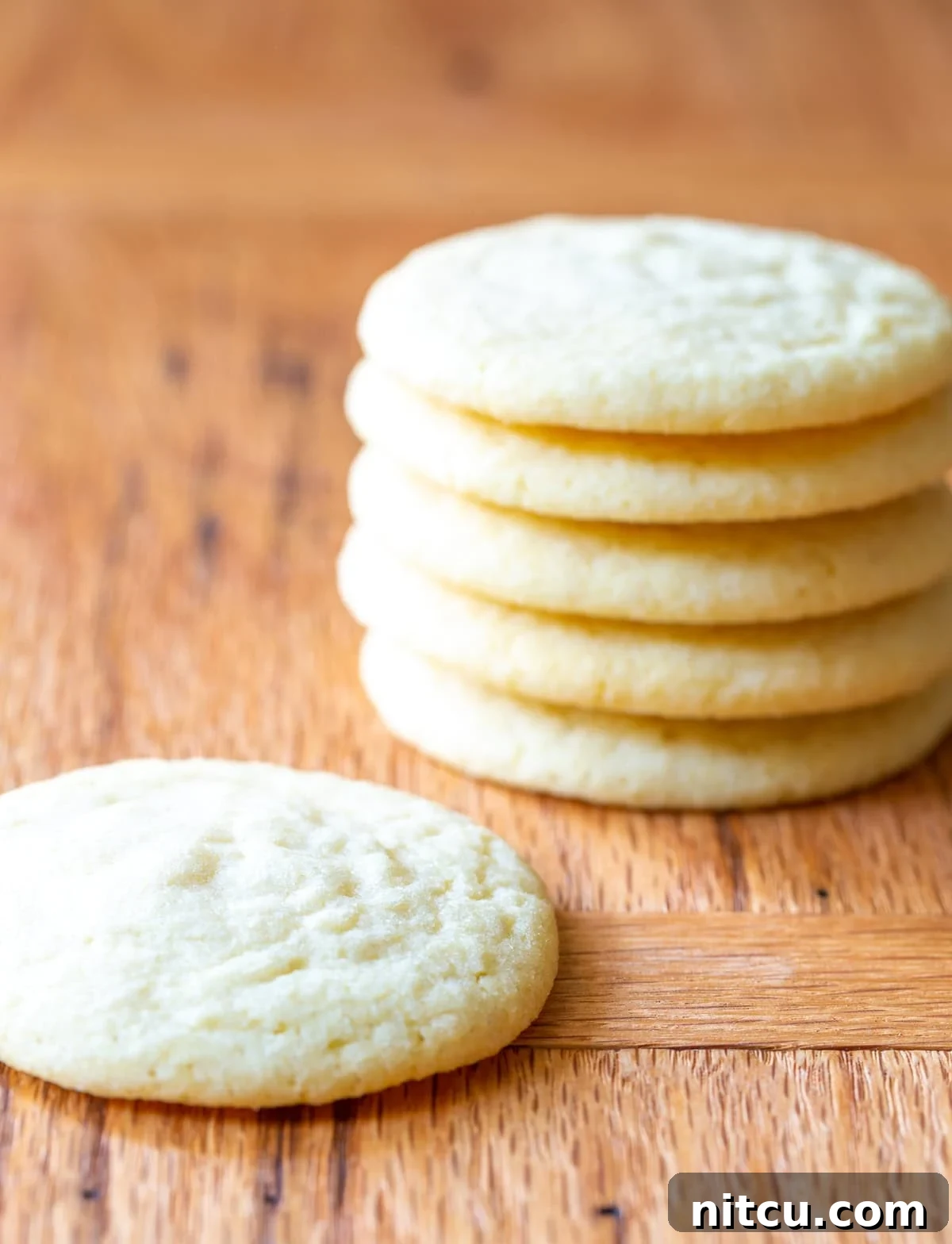 worlds-best-cookie Side view of a stack of the world's best sugar cookies recipe, showing off their perfectly baked texture and golden-brown undersides.