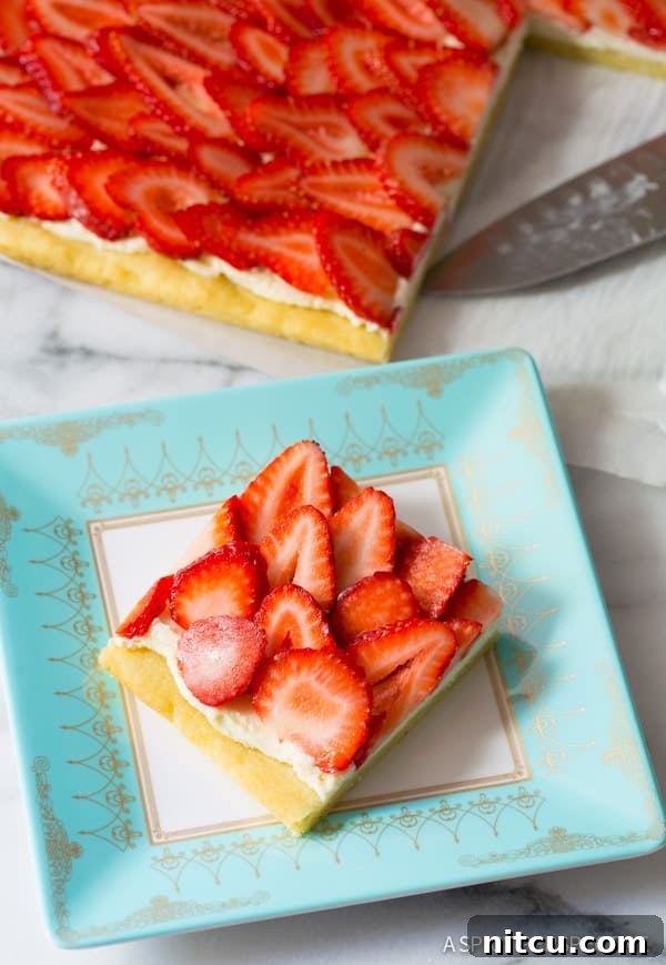 Divine Strawberry Cookie Pizza Delight 5 Overhead view of a finished strawberry fruit pizza, garnished and ready.