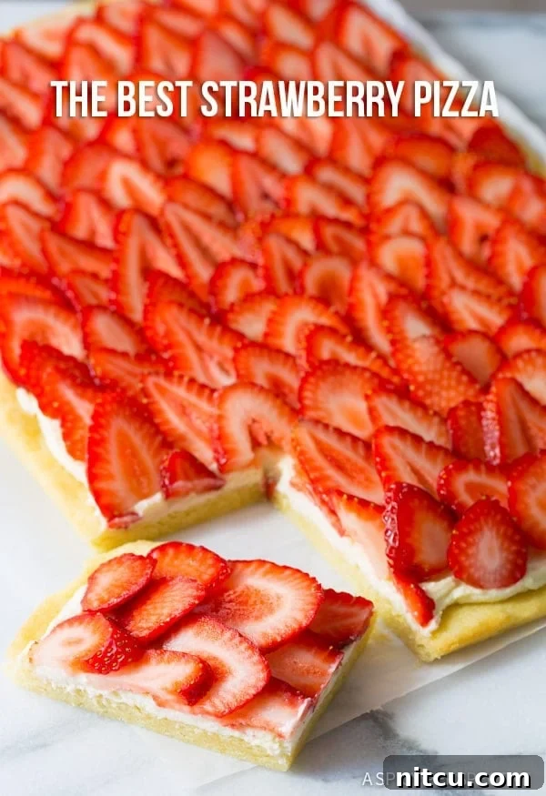 Dessert Pizza, Strawberry Treat A slice of strawberry dessert pizza, showcasing the layers of cookie, goat cheese, and fresh fruit.