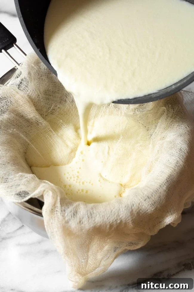 Crafting Creamy Ricotta at Home 9 Carefully pouring the curdled milk mixture into the cheesecloth-lined sieve, initiating the separation of creamy curds from clear whey.