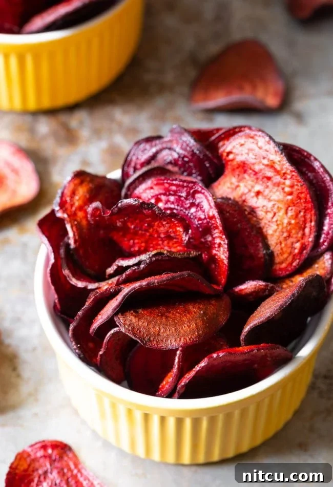 Wholesome Beet Crisps 2 Top view of beet chips in a yellow ramekin. A perfect healthy snack.