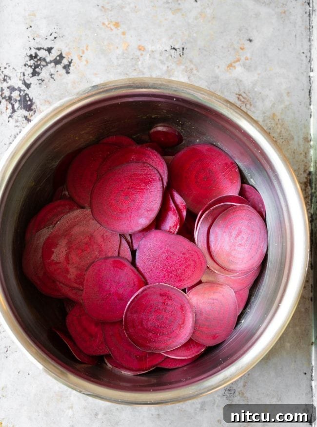 Wholesome Beet Crisps 5 The beetroot “sweating” in salt and oil in a metal bowl to release moisture.