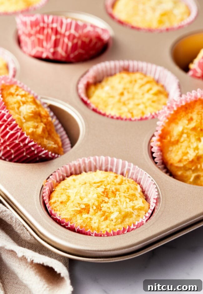 Tropical Sunrise Muffins 4 Baked tropical breakfast muffins in a muffin tin.