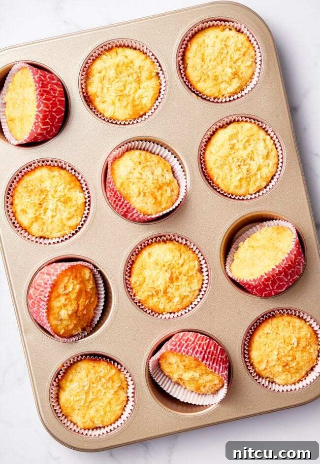Tropical Sunrise Muffins 8 Baked tropical breakfast muffins in a muffin tin.