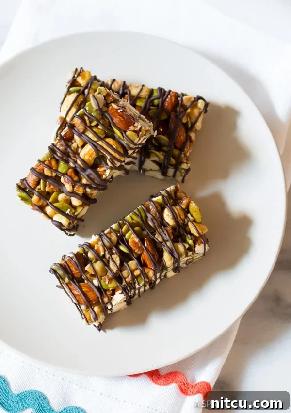 A close-up shot of a single paleo nut bar with chocolate drizzle, highlighting its crunchy texture and delicious topping.