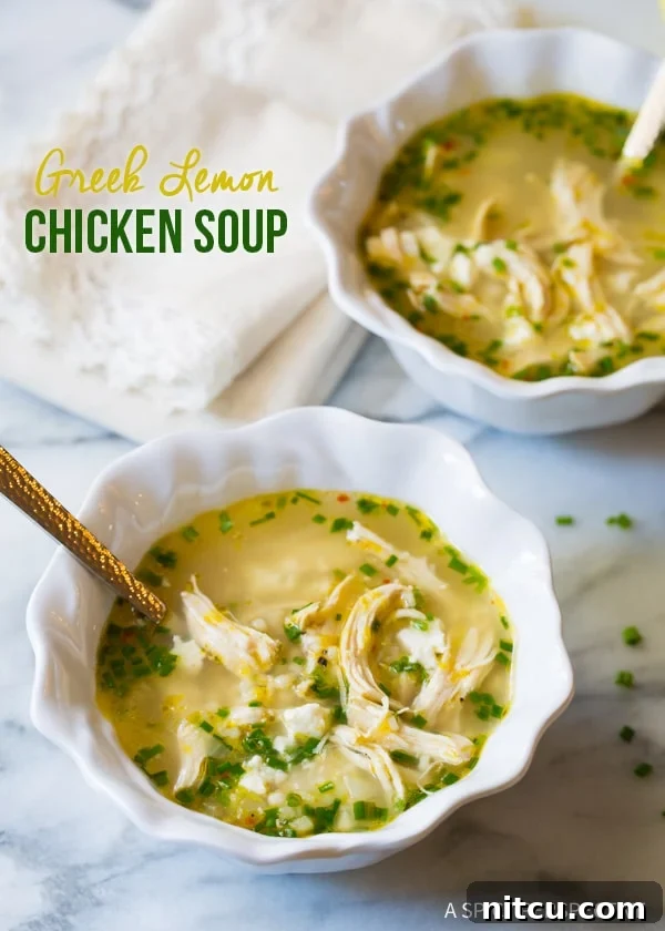 Healthy Greek Lemon Chicken Soup Recipe Two steaming bowls of Greek lemon chicken soup with fresh lemon slices and feta on a kitchen counter, ready to be enjoyed.