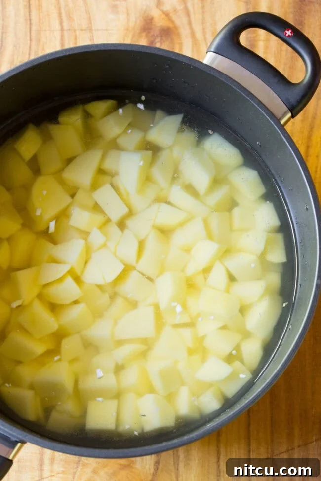 mashed potatoes recipe Chopped up potatoes in a pot ready to boil and become tender