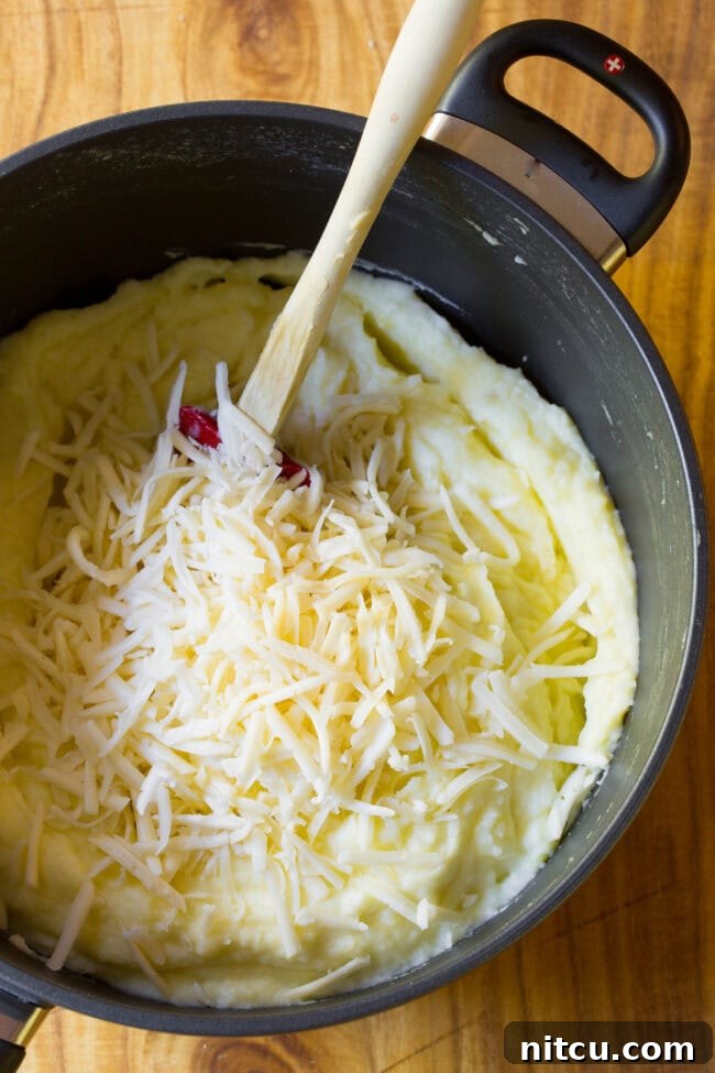 best mashed potatoes top view of mashed potatoes with cheese ready to stir in