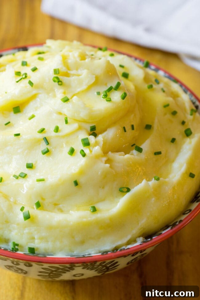 best mashed potatoes recipe Small bowl full of the best mashed potatoes ready to be served.