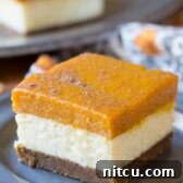 Yummazing Layered Pumpkin Cheesecake Bars on ASpicyPerspective.com