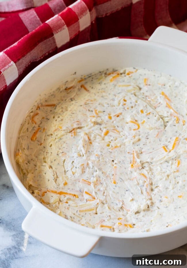 Fully Loaded Pizza Dip 5 White dish with cream cheese mixture spread evenly in the bottom.