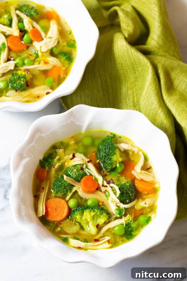 A steaming bowl of vibrant chicken detox soup, garnished with fresh herbs, ready to be enjoyed as a healthy and comforting meal.