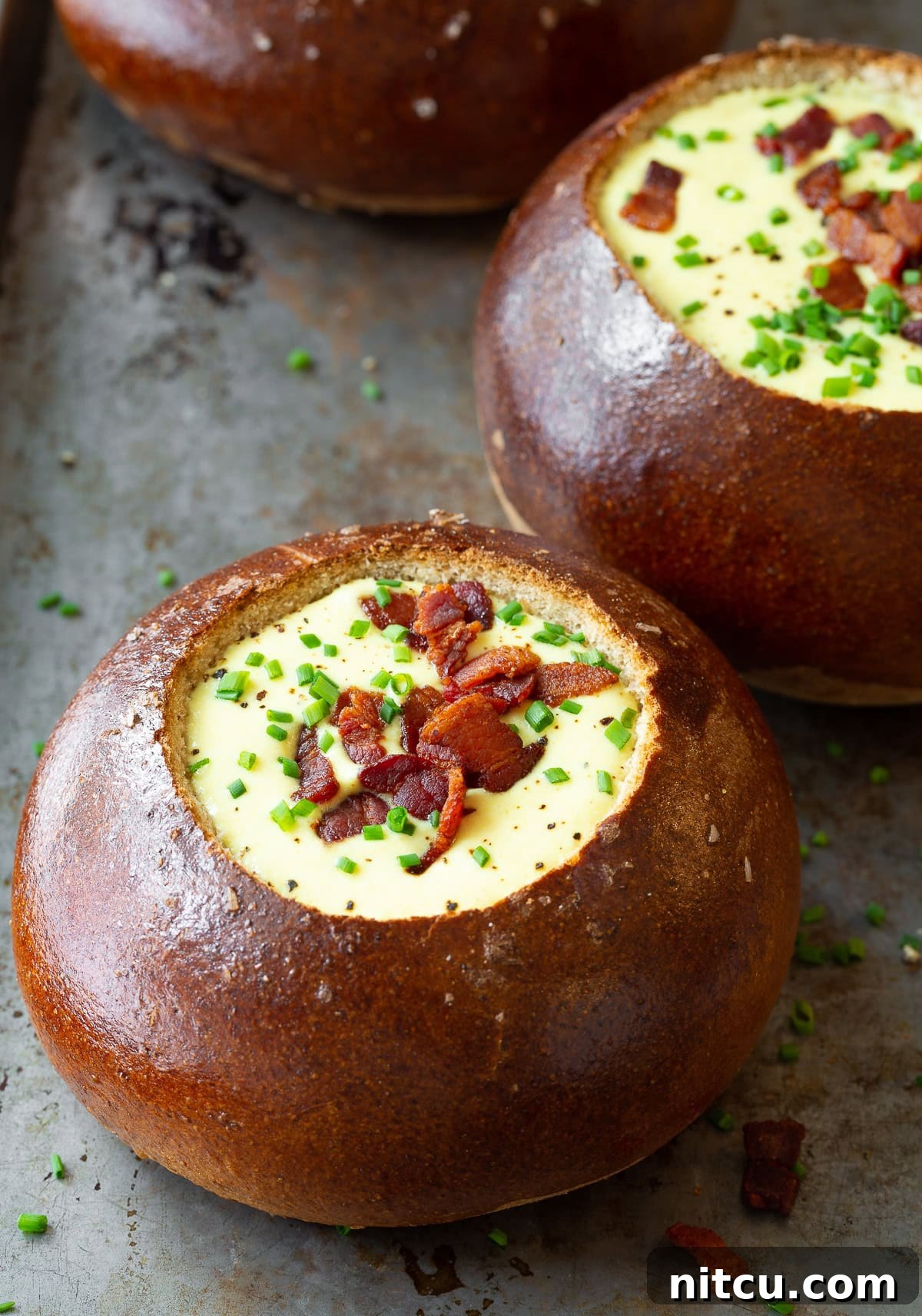 Warm bread bowls perfectly filled with creamy Irish Beer Cheese Soup.