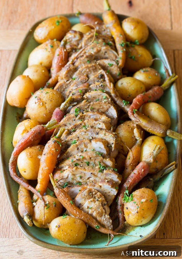 Melt-in-Your-Mouth Slow Cooker Pork Loin and Root Veggies 10 Crockpot Pork Loin with Vegetables served on a platter with potatoes, carrots, and onions