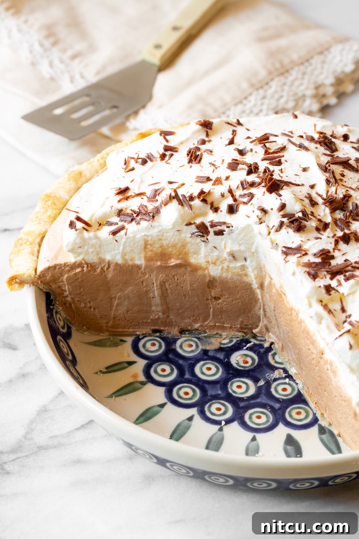 Chocolate Cream Pie #ASpicyPerspective #FrenchSilkPie #SilkPie #FrenchSilkPieRecipe #ChocolateSilkPie #Chocolate #Silky #Fluffy #Pie #Dessert A whole easy French Silk Pie recipe, cut open to reveal the rich chocolate filling and thick whipped cream layers.