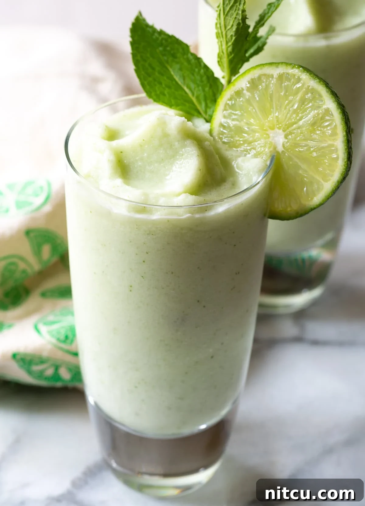 Best-Mojito-Recipe Close-up of a garnished Frozen Coconut Mojito glass