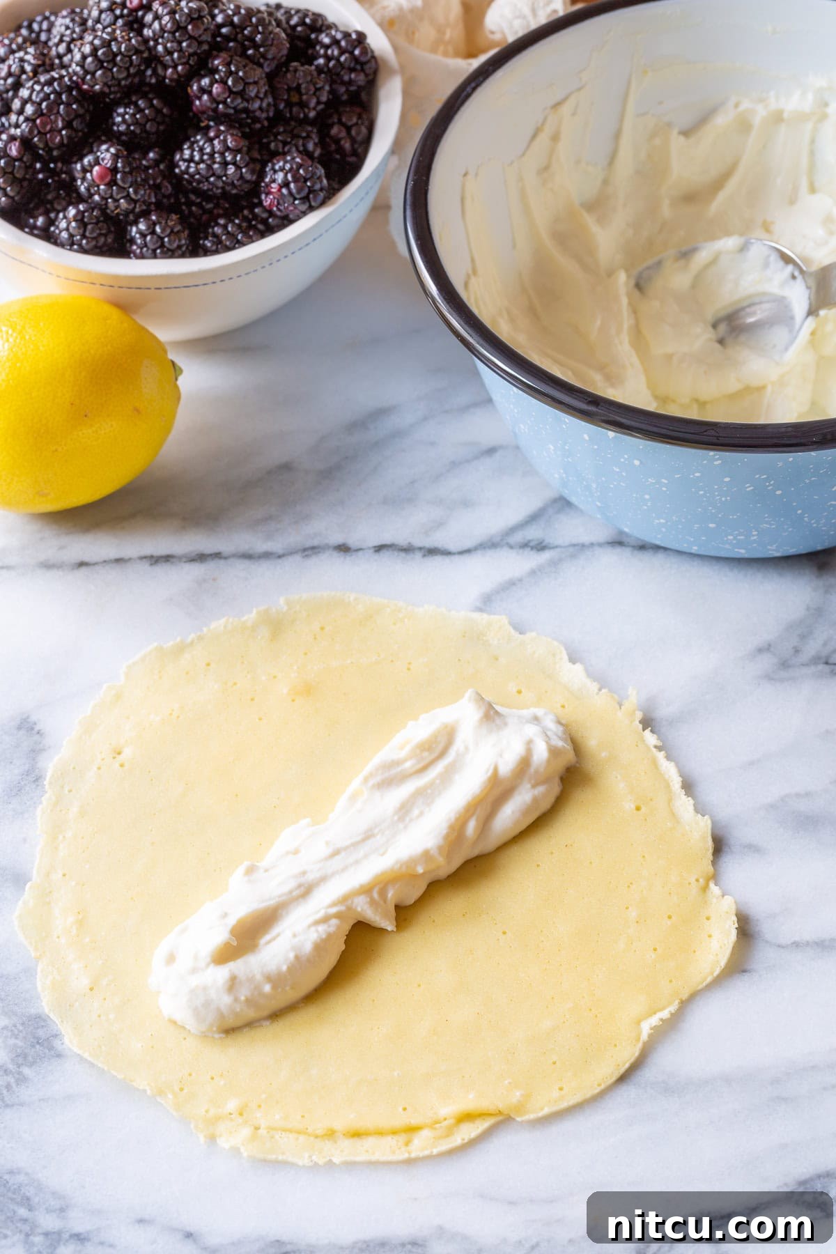 Golden Cheese Blintzes 6 Spreading sweet ricotta cream evenly over a freshly cooked blini pancake