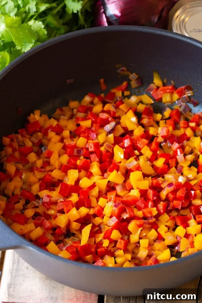 Tropical Island Rice 4 Diced vegetables being sautéed in a pan.