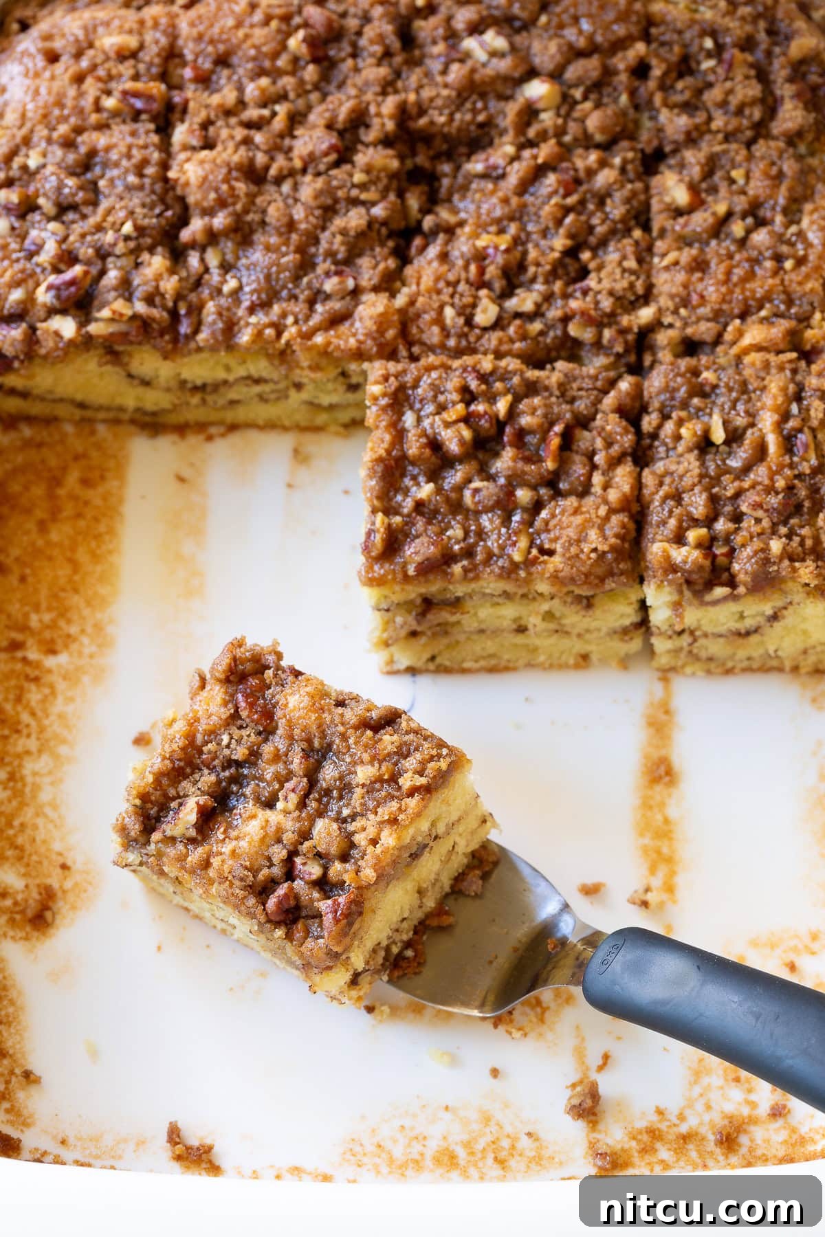 Decadent Kahlua Coffee Cake 7 Kahlua Coffee Cake - cut into squares with layers showing - on piece on spatula ready to lift, enticingly moist