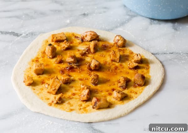 Umami Grilled Teriyaki Chicken Pizza 8 How to Make Grilled Chicken Teriyaki Pizza with toppings arranged on dough.