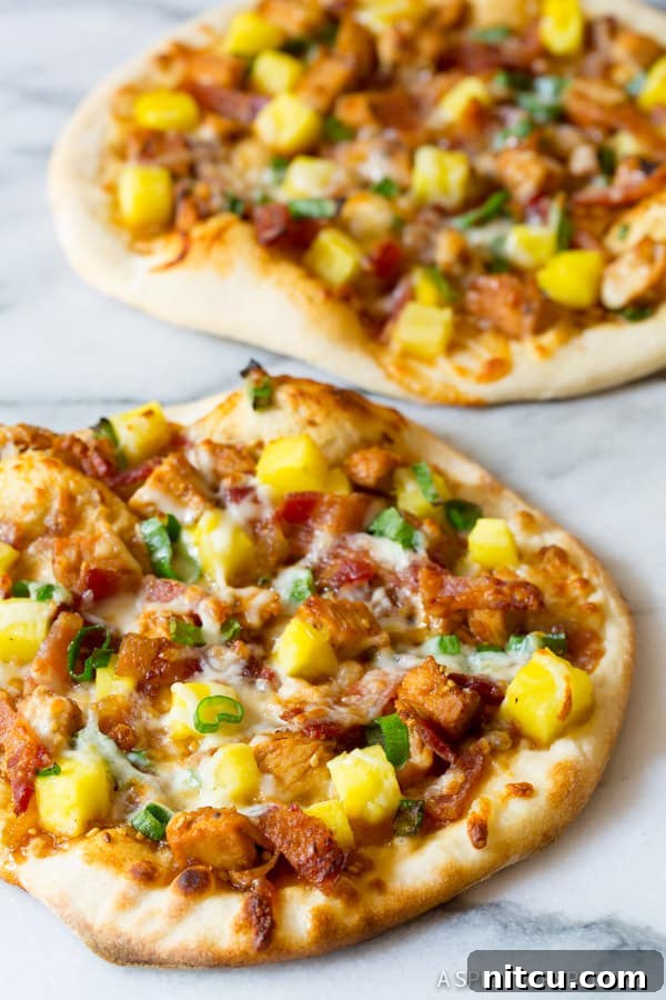 Umami Grilled Teriyaki Chicken Pizza 10 Teriyaki Pizza with chicken and pineapple, close up shot, highlighting the melty cheese and toppings.