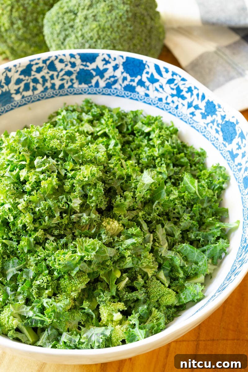 A vibrant assortment of broccoli salad ingredients laid out, including bacon, dried cherries, and sunflower seeds.
