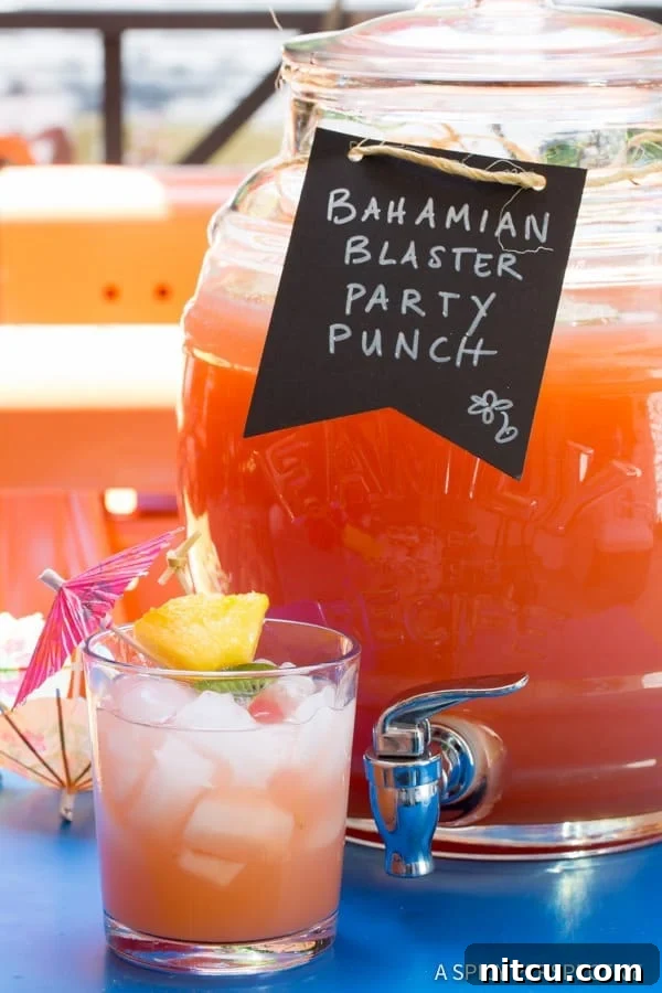 Refreshing Bahamian Party Punch with Rum Bahamian Rum Punch Recipe in glass in front of large jug