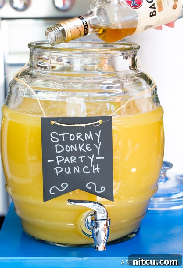 Mule Kick Monsoon Brew 3 Mixing the ingredients for Stormy Donkey Party Punch in a large beverage dispenser, ready for a party.