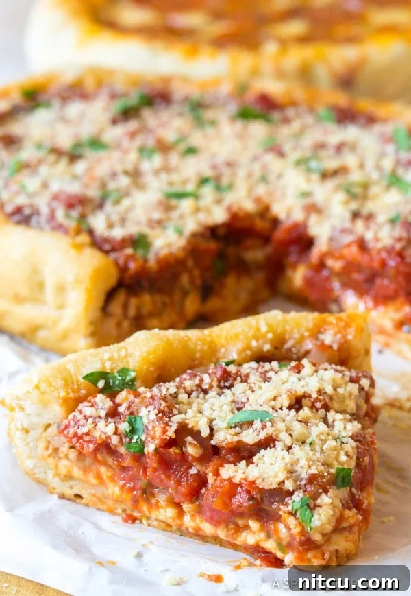 A perfectly cooked slice of deep dish pizza from the crockpot, rich with melted cheese, savory sausage, and vibrant tomato sauce, ready to be enjoyed.