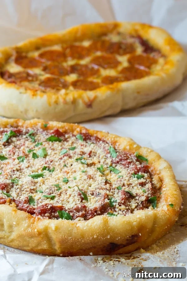 A delectable slow cooker pizza, half-eaten, showcasing its layers of cheese, sauce, and sausage, resting on a white parchment paper.
