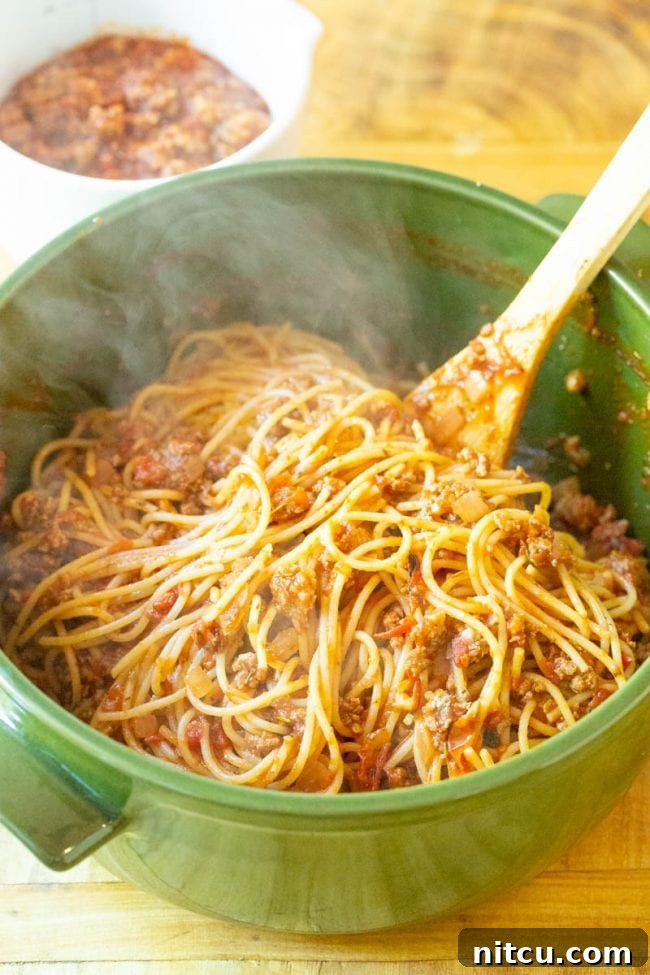 Crushed tomatoes, tomato paste, and Italian seasoning added to meat mixture.