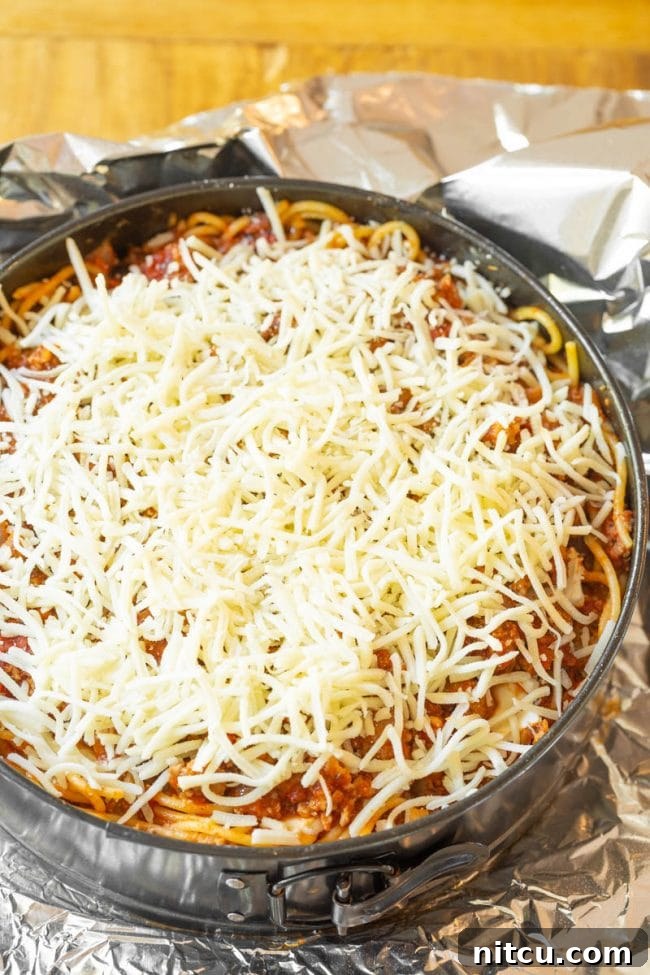 Slices of cream cheese laid over the spaghetti layer.