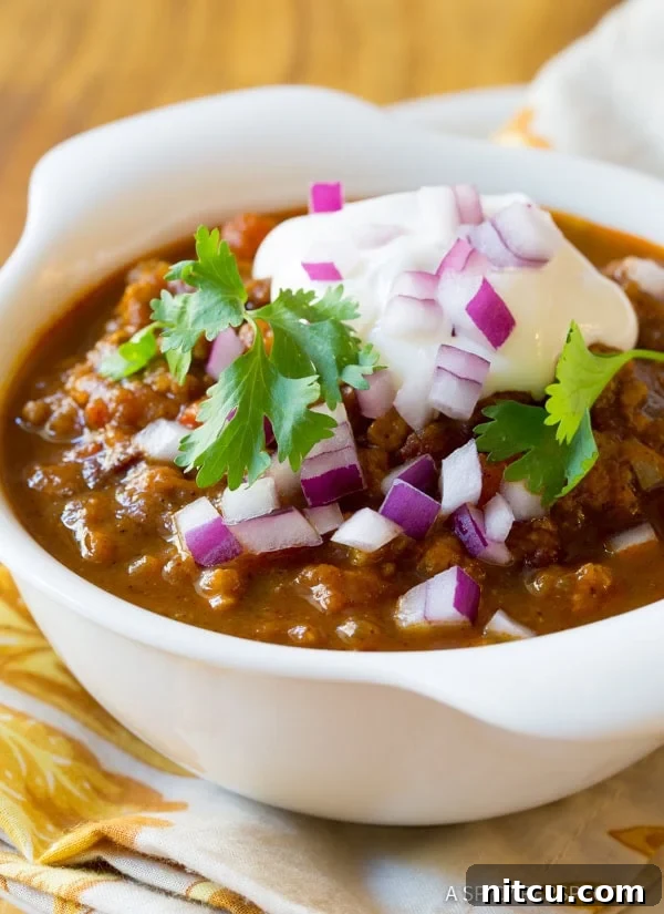 Chili with all of the toppings like cilantro, sour cream and onions. 