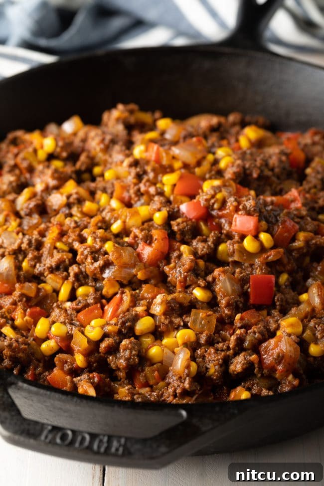 Ground beef filling for tamale pie in a skillet. 