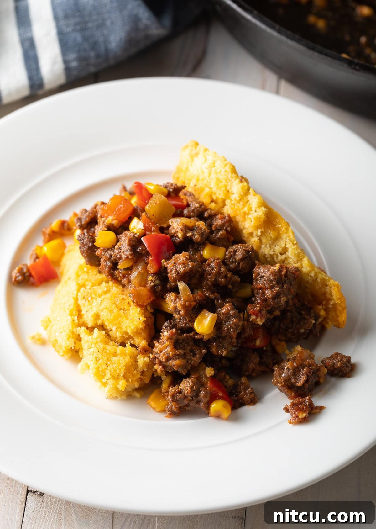 Portion of tamale pie on a white plate. 