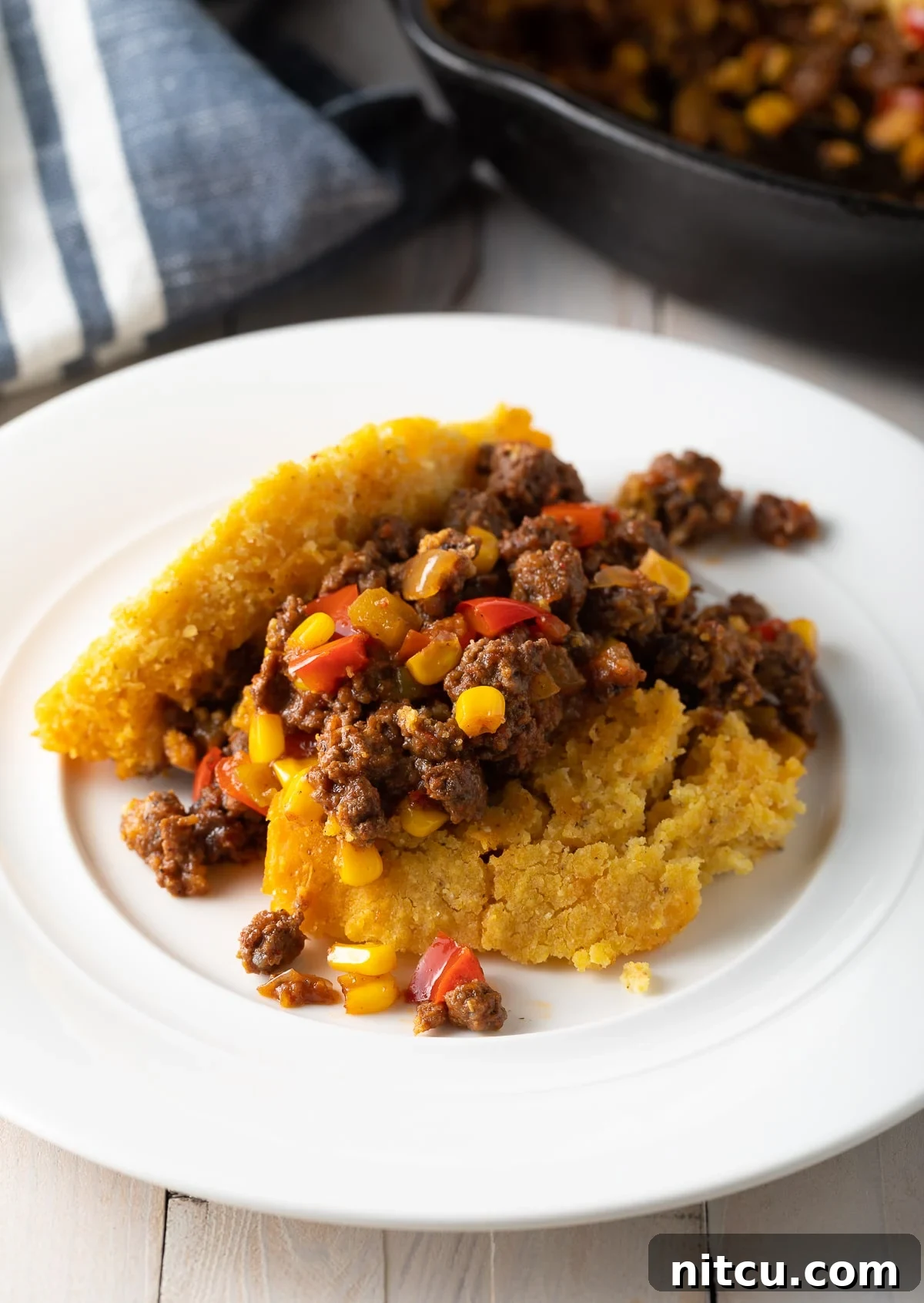 Serving of tamale pie served on a white plate. 