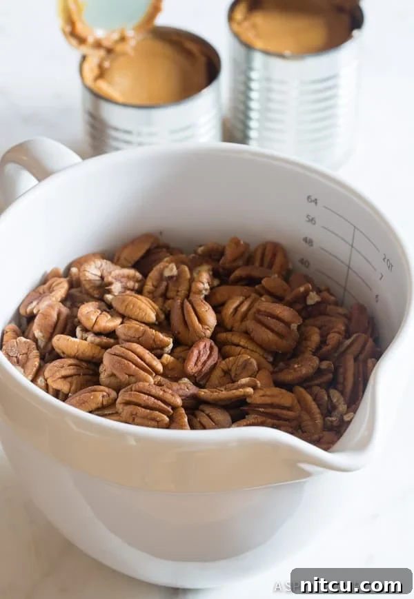 Decadent Pecan Pie Bars 2 Shelled pecans gathered in a mixing bowl, ready for the caramel filling.