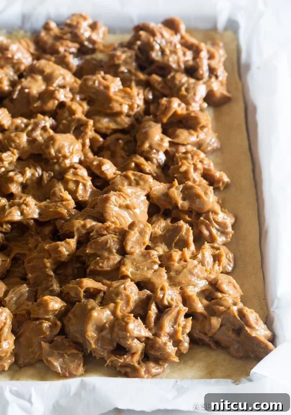 Cookie-Base-with-Filling Close-up of the cookie pie base with the rich caramel pecan mixture evenly spread on top, before final baking.