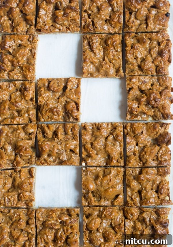 Dessert-Bars-Presentation An overhead shot of decadent pecan pie dessert bars arranged artfully.