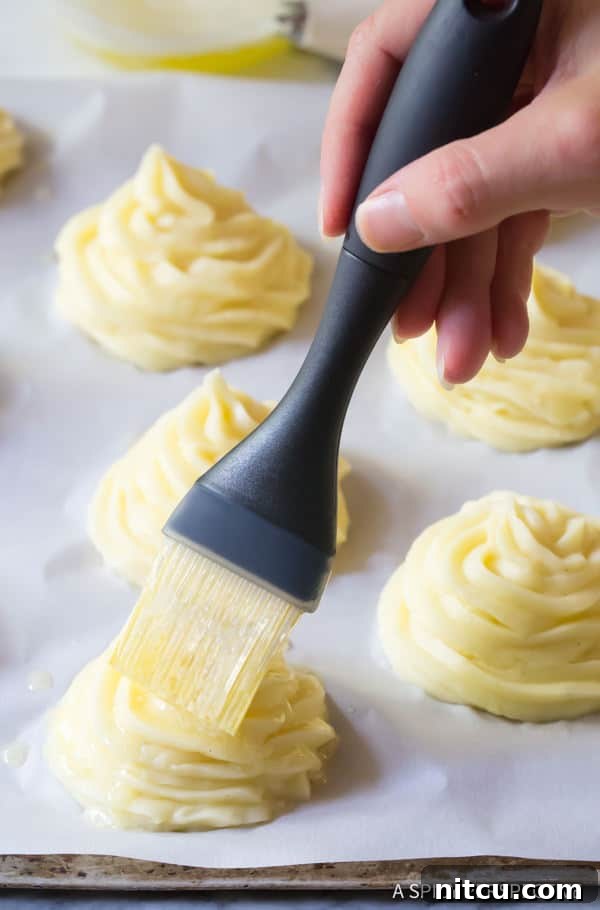 Perfect Duchess Potatoes 6 Duchess Potato on baking sheet, brushed with butter