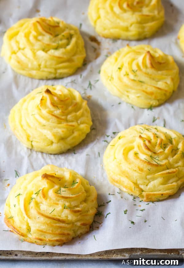 Perfect Duchess Potatoes 7 The Best Ever Duchess Potatoes Recipe on baking sheet with chopped herbs