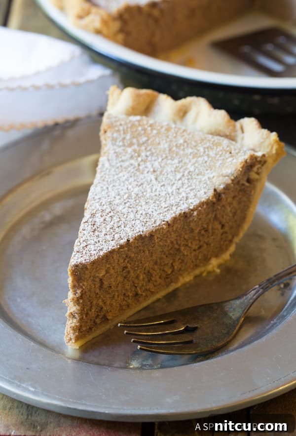 Slice of cinnamon pie on a plate with a fork. 