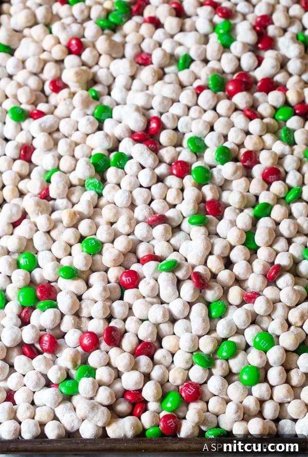 Finished Simple Snowball Party Mix with peanut butter, white chocolate, cinnamon, and M&Ms