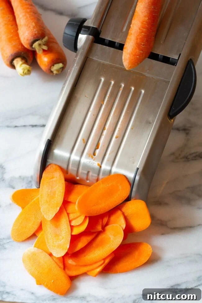 Crunchy Carrot Crisps 5 Carrots being expertly sliced by a mandolin for thin chips.