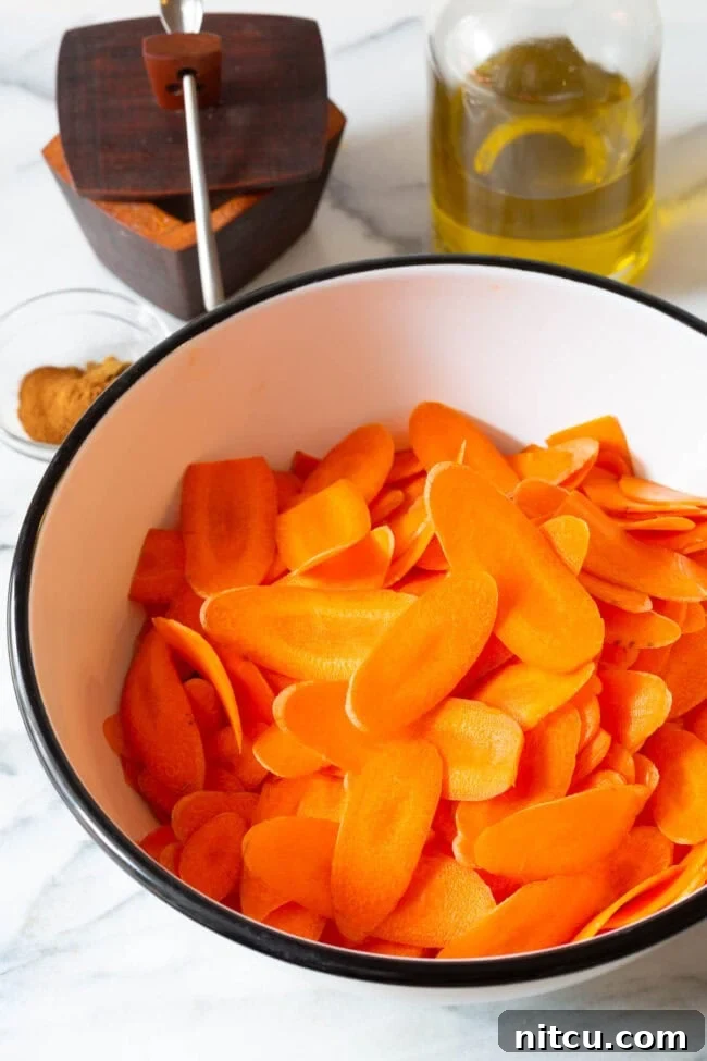 Crunchy Carrot Crisps 6 Thin carrot slices perfectly prepped in a bowl, ready for seasoning.