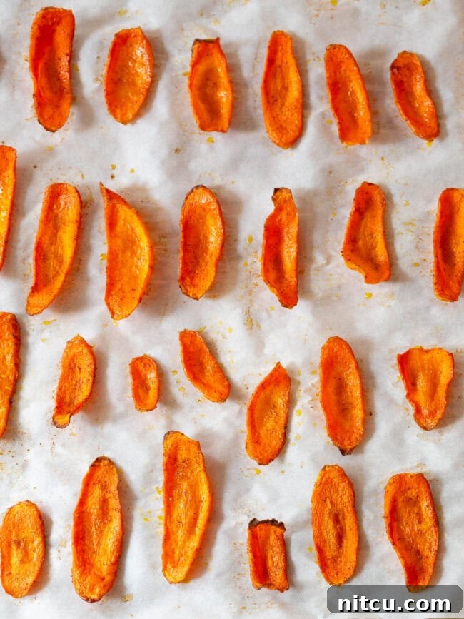 Crunchy Carrot Crisps 8 Freshly baked and crispy carrot slices on a baking sheet, ready to enjoy.