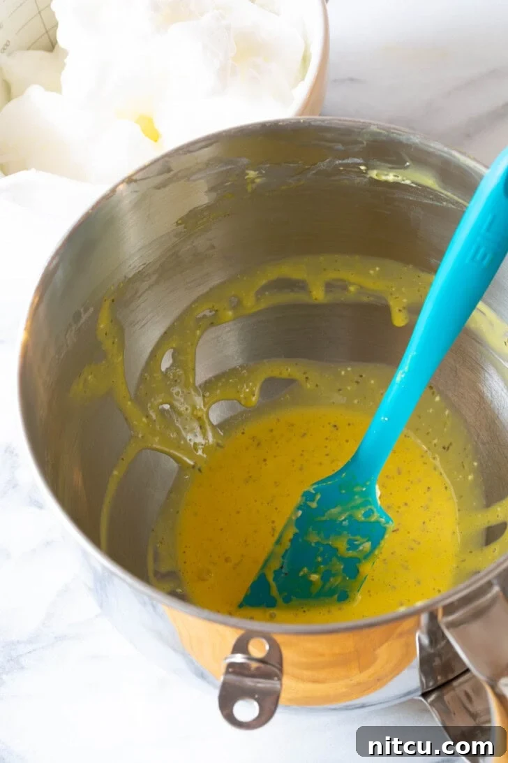 Egg Mixture #LowCarb #GlutenFree #GrainFree #Keto #CloudBread #KetoCloudBread #NoCarbBread A stand mixer bowl filled with whipped egg yolks, beautifully blended with Italian seasoning, ready for the next step.